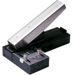 Stapler style slot punch with adjustable guide